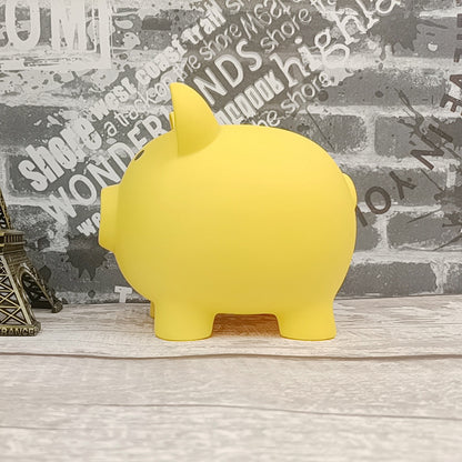 Yellow piggy bank on a wooden surface with a decorative wall background