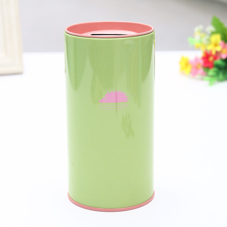 Green cylindrical container with pink rim on a white background. Hedgehog on tinplate.