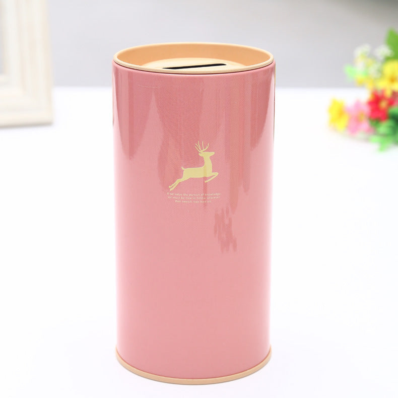Pink cylindrical product with gold deer design on a white background. Deer on tinplate.