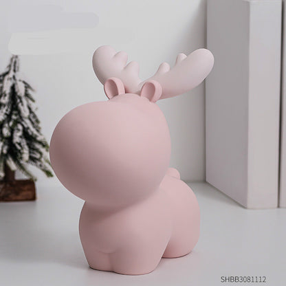Pink moose-shaped decorative item on a white surface with a blurred background. Piggy bank.
