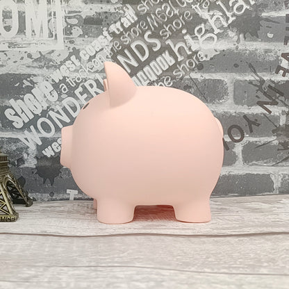 Pink piggy bank on a wooden surface with a decorative wall in the background